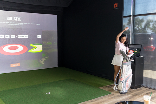 Woman playing at Fairway Indoor golf facilities